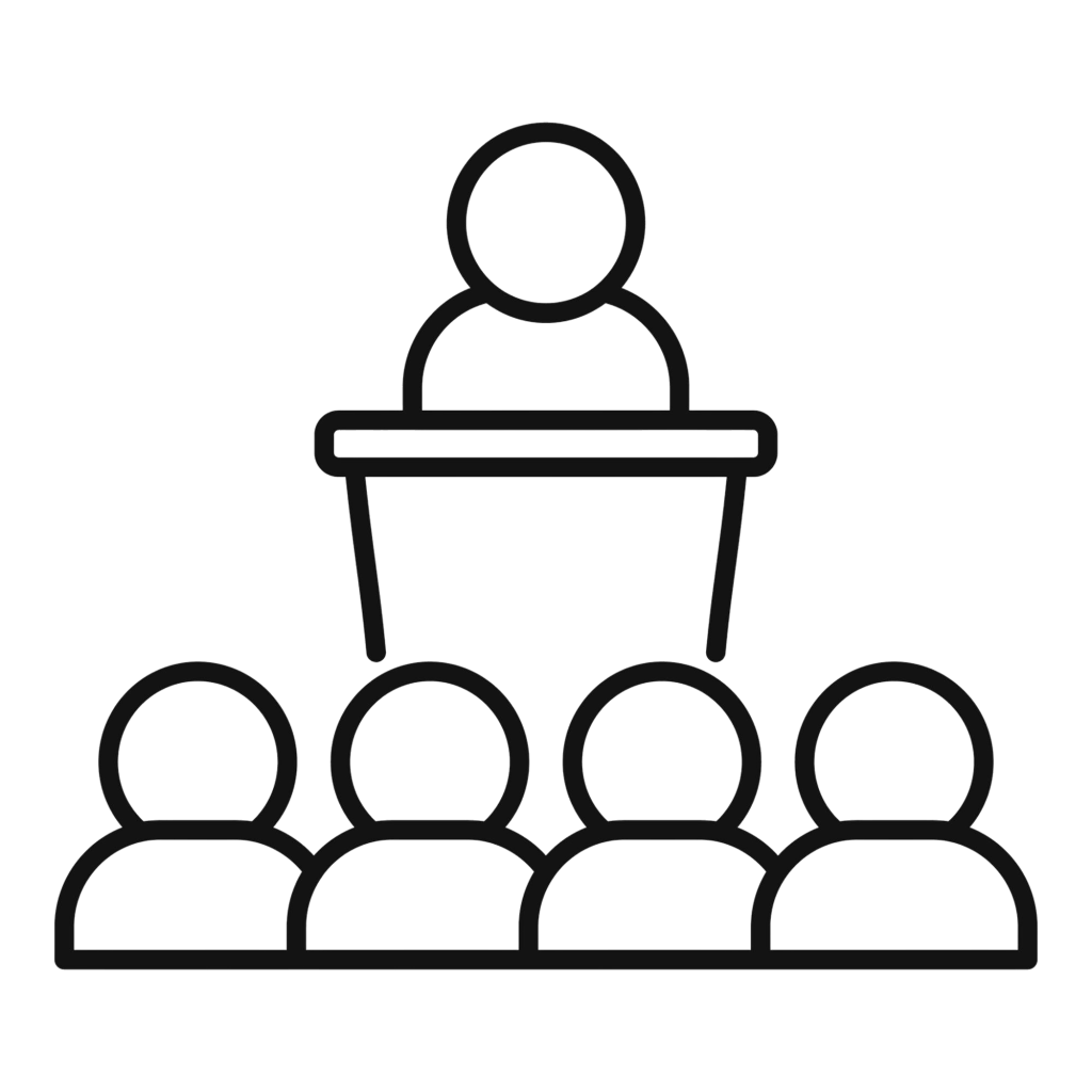 businessman making speech stage audience colleagues sitting front him.png